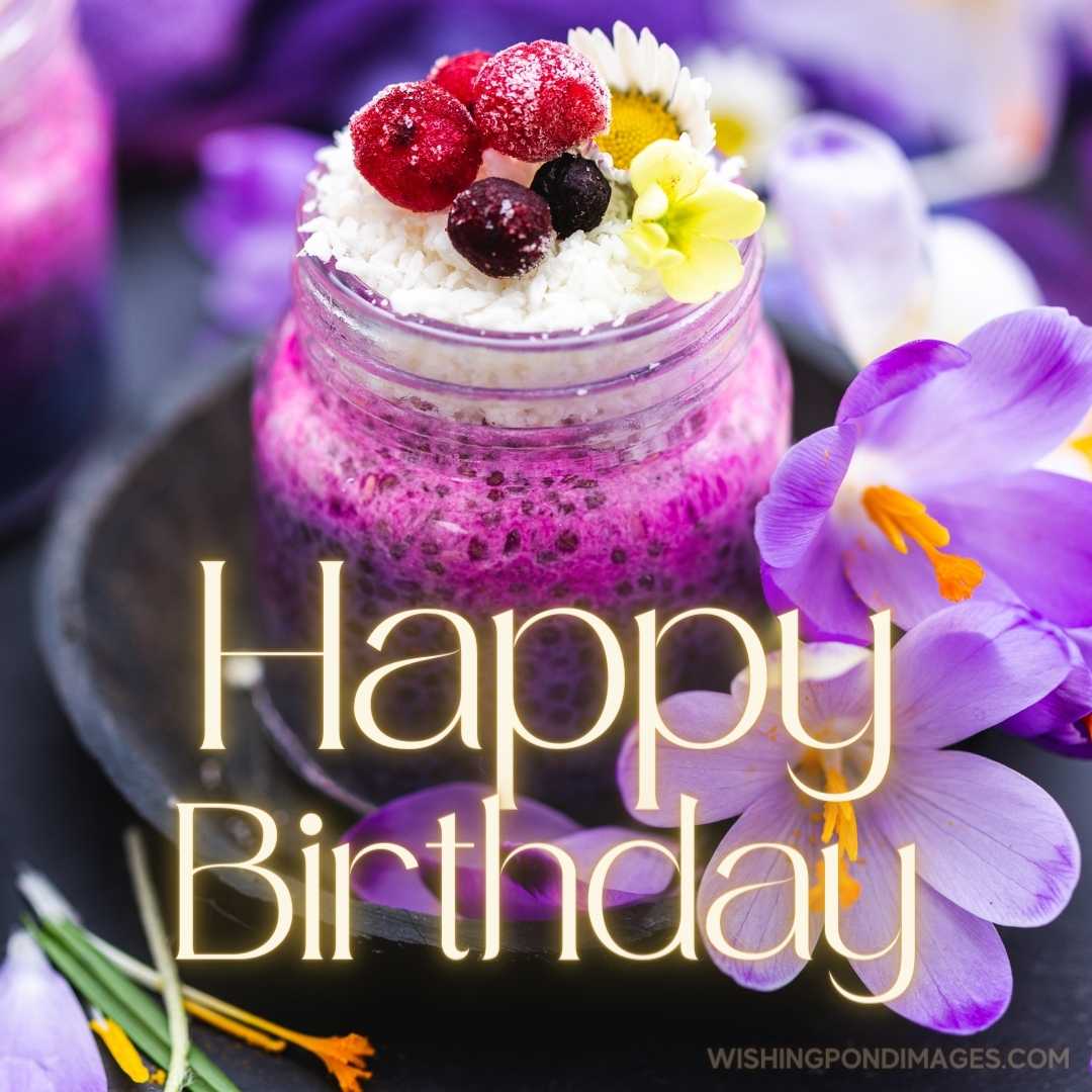 An enticing looking like a jar of purple vegan smoothie topped with berries, surrounded with purple 